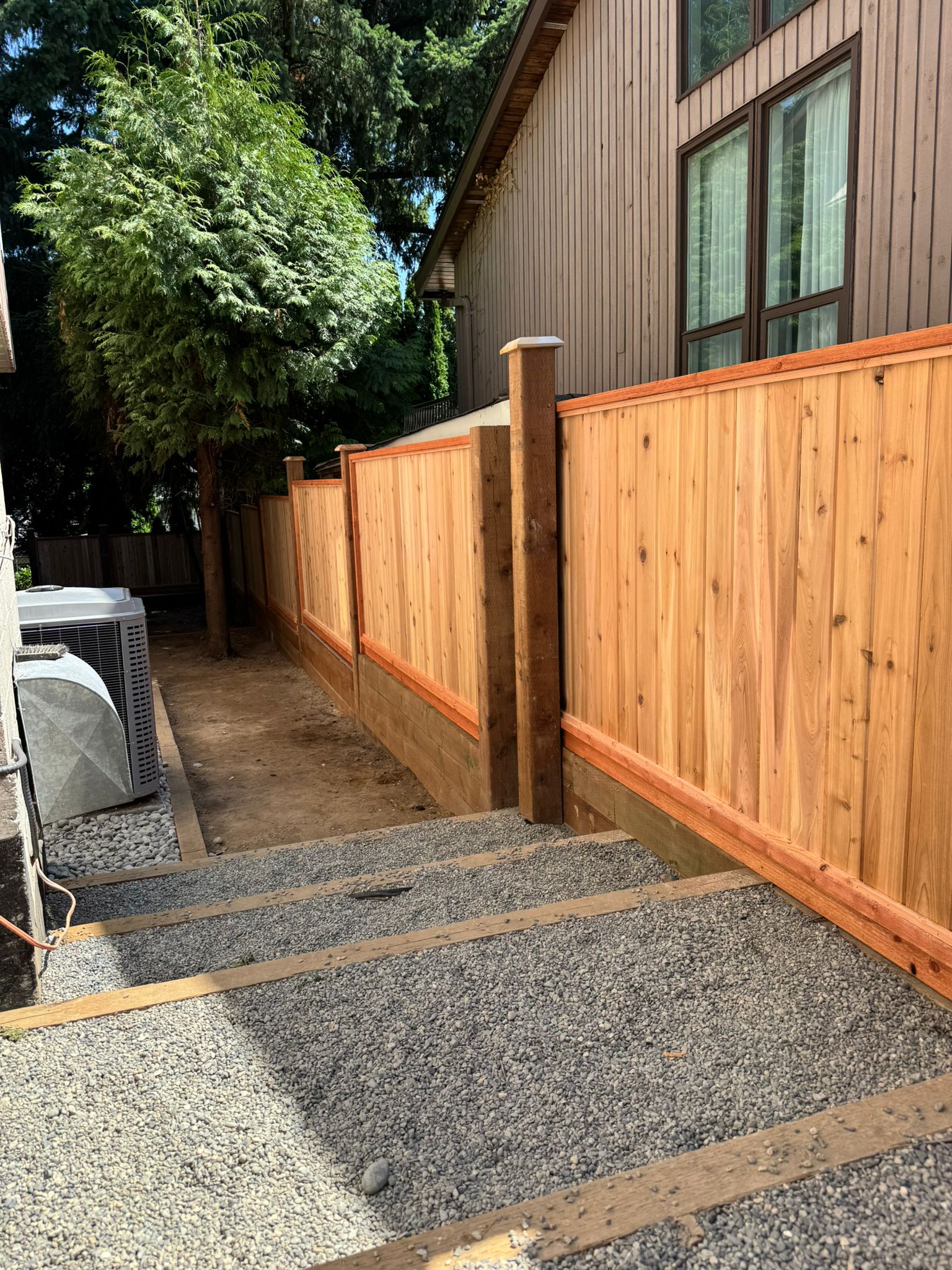 Completed cedar fence replacement in a residential backyard
